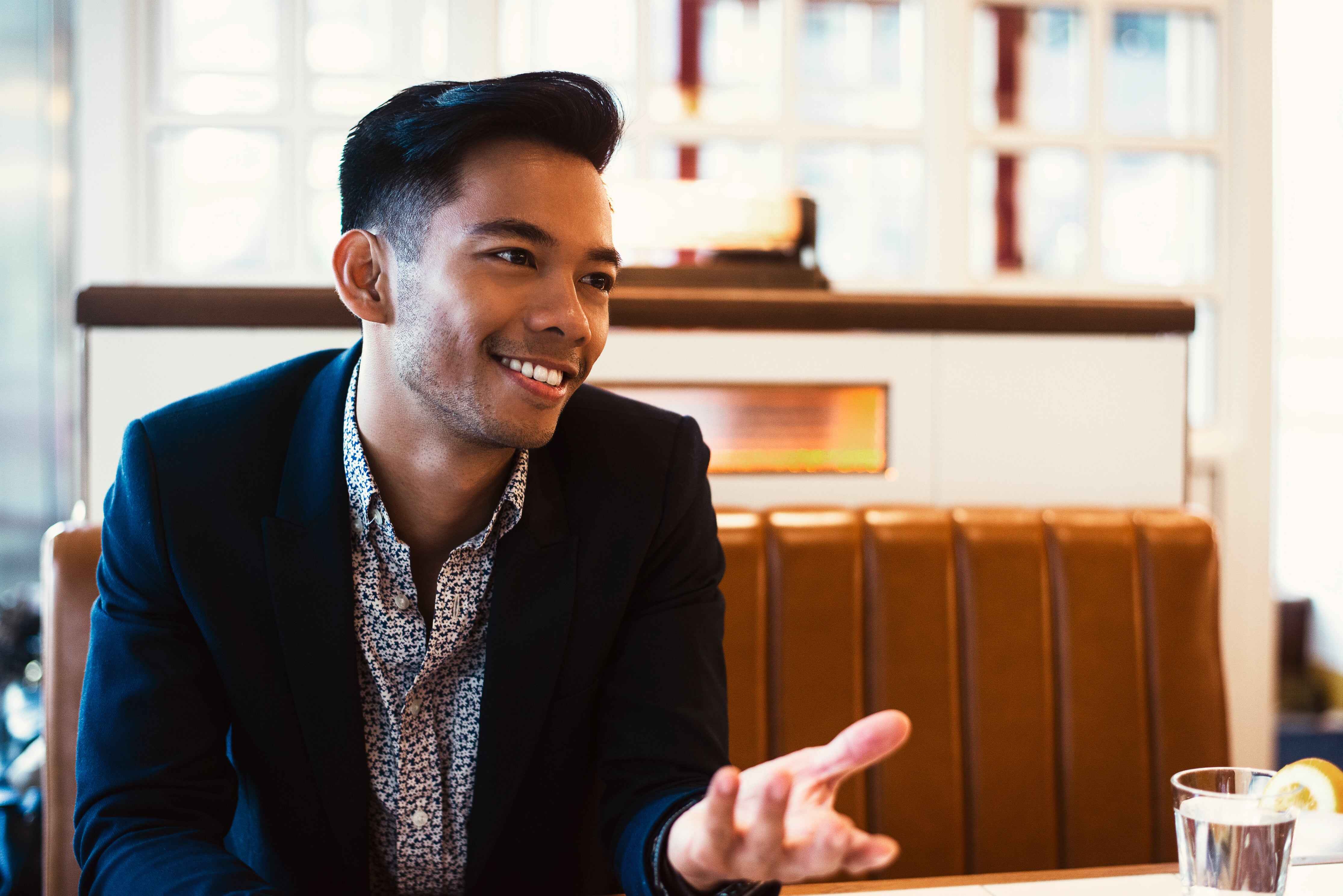 man casually talking at a restaurant table