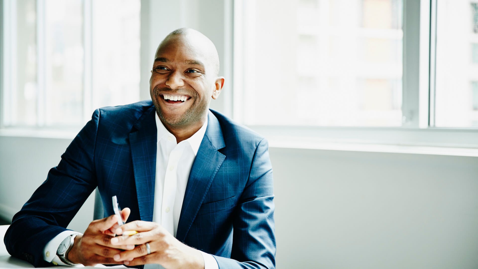 man-smiling-at-desk-career advice