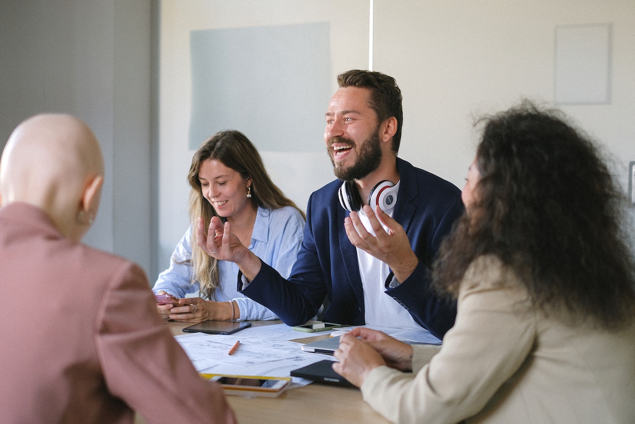 manager-laughing-with-employees-at-meeting-new-manager-coaching