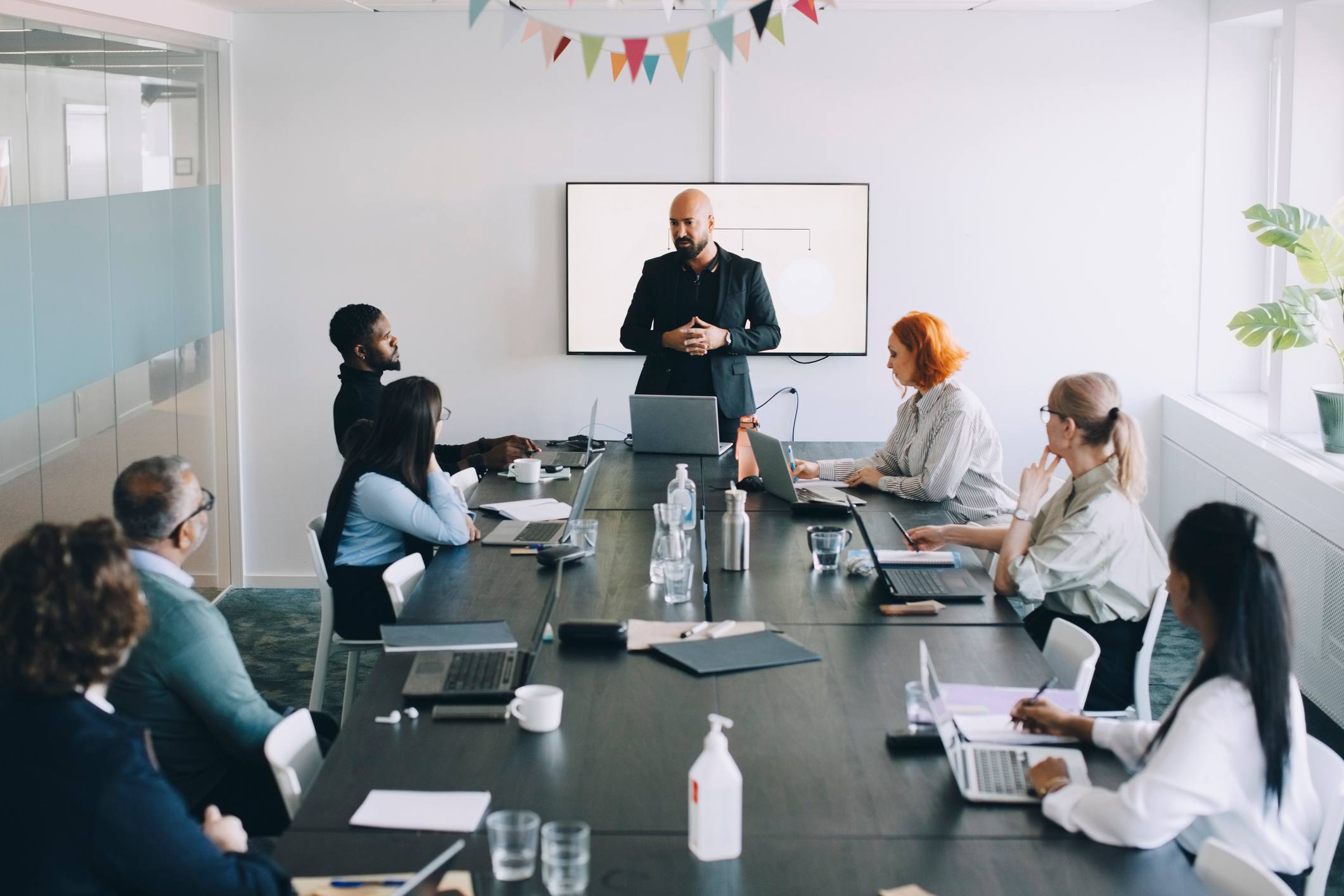 Manager-talking-to-his-team-at-work-meeting-examples-of-behavioral-goals