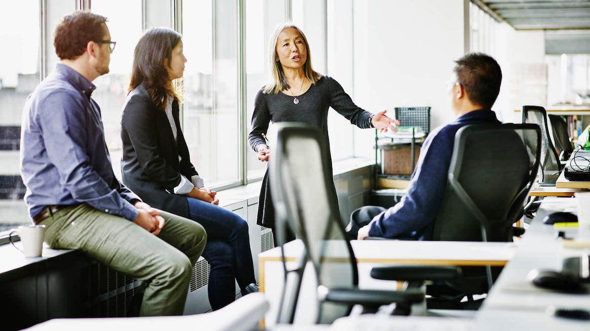 managing-managers-team-leader-in-meeting-speaking