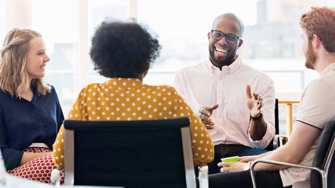 peak-performance-employees-laughing-in-team-meeting