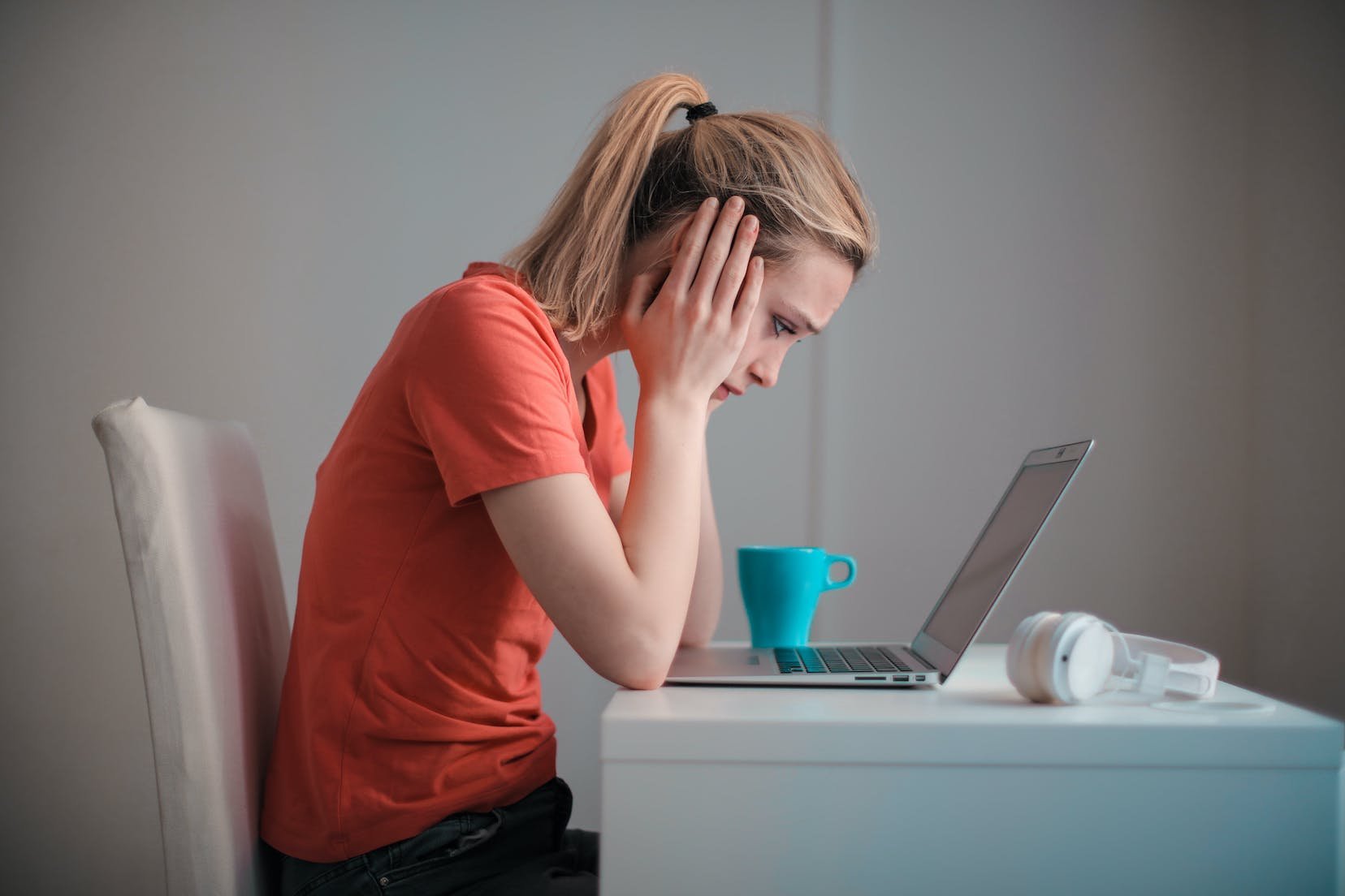 woman-sits-in-front-of-laptop-feeling-inferior