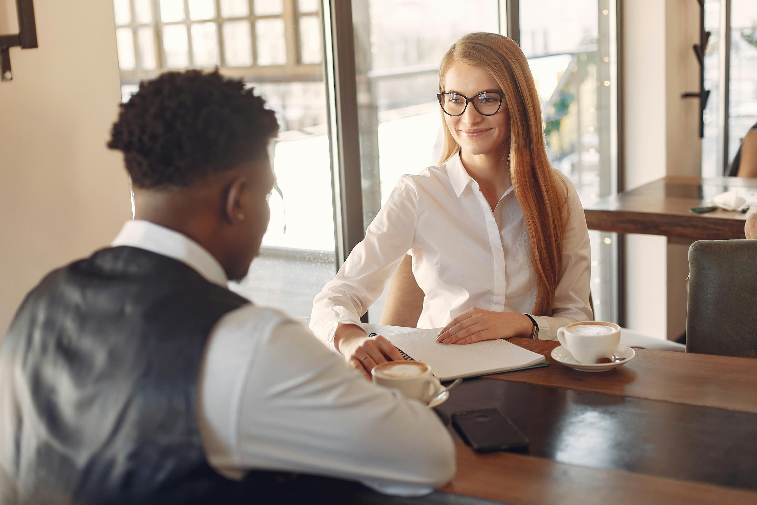 two-people-sitting-at-a-table-practicing-career-aspirations-examples