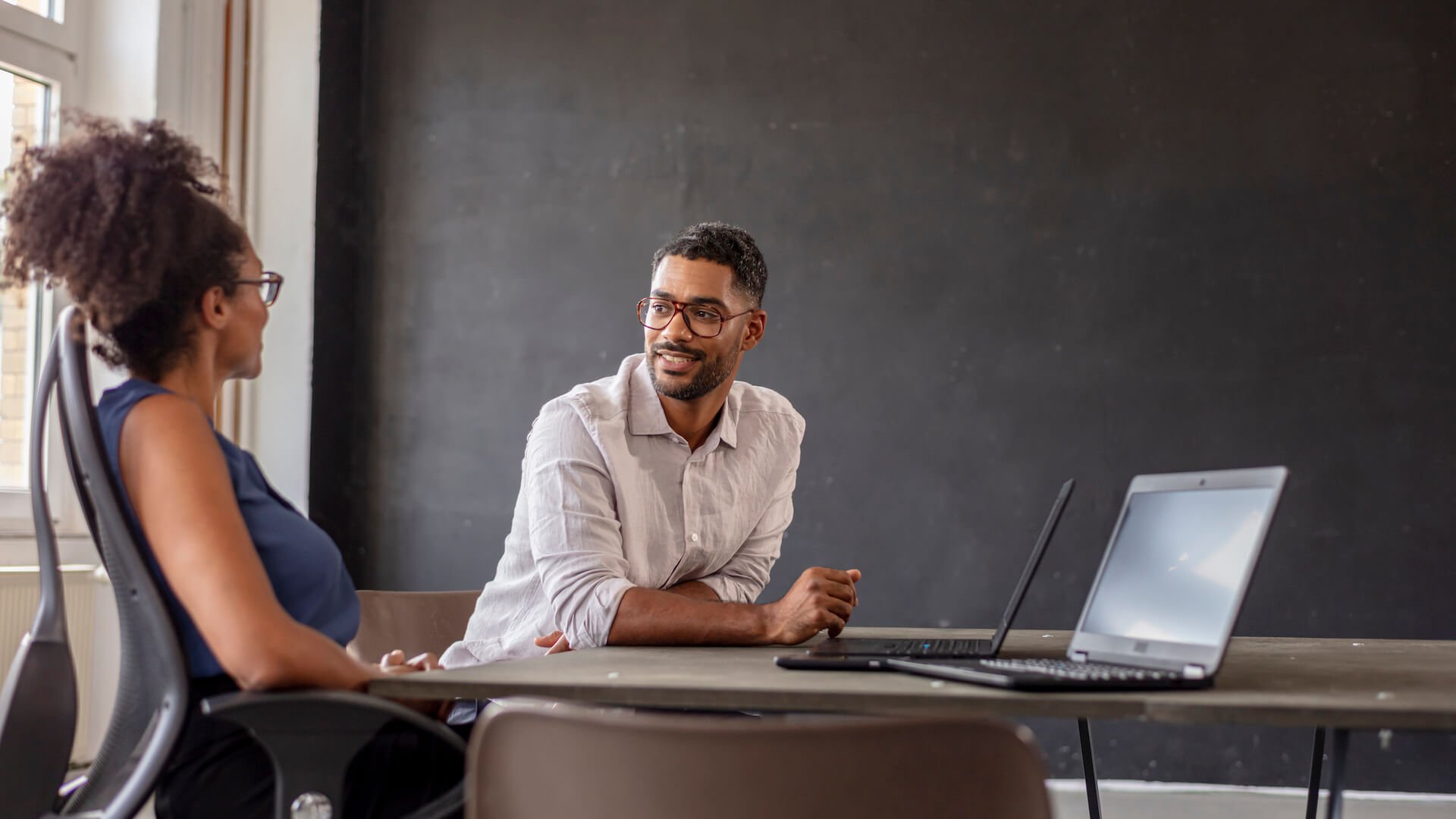 two-people-talking-at-a-desk-career-coaching-topics