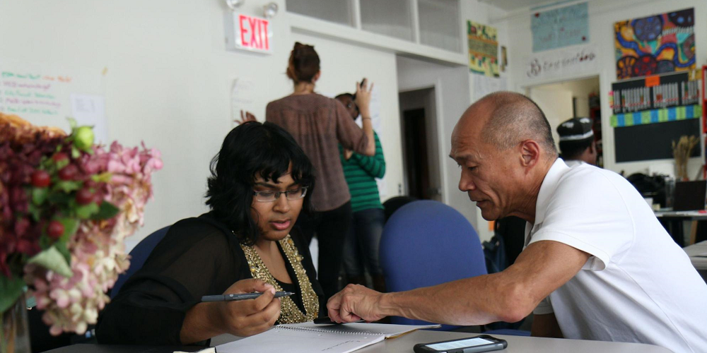 man-mentoring-a-woman-at-work